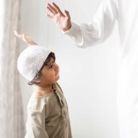Muslim boy giving a high five